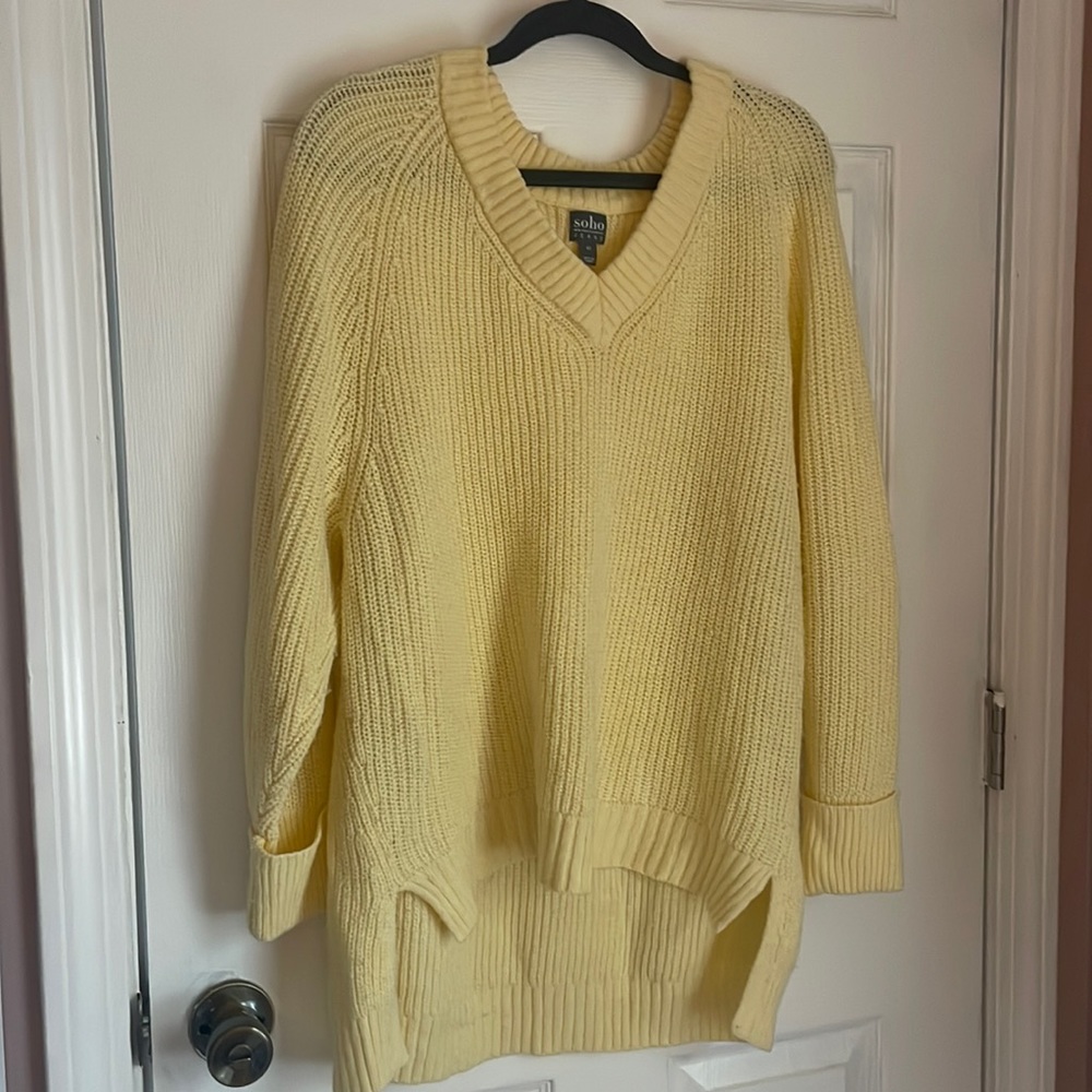 A knitted pull over yellow sweater